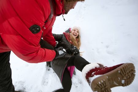 Couple in love playing in the snowの写真素材