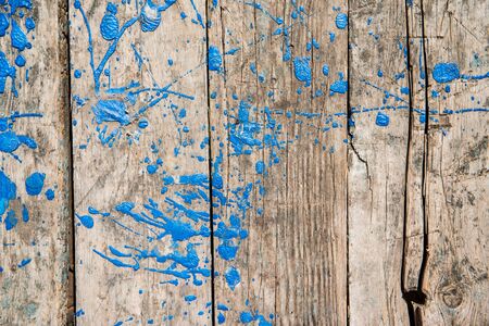 Old weathered wooden planks with blue stains of paintの写真素材