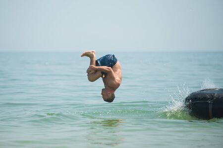 Man jumps from an inflated camera into the sea