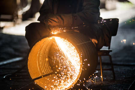 Worker doing a industrial welding in a workshopの写真素材