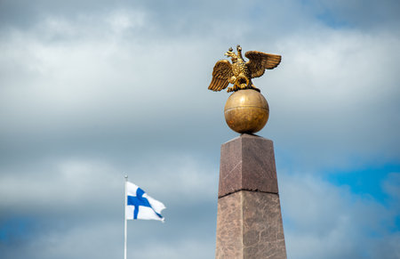 obelisk with Double-headed eagle and the flag of Finland in Helsinkiの写真素材