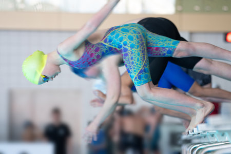 Swimmer girl start from the starting table in the poolの写真素材