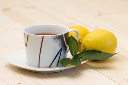 cup of tea and two fresh lemonsの写真素材