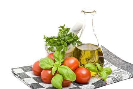 bottle of olive oi, tomatoes, basil and parsleyの写真素材