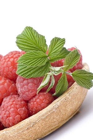 fresh raspberries on a plate, on white backgroundの写真素材