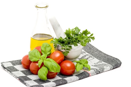 bottle of olive oi, tomatoes, basil and parsleyの写真素材
