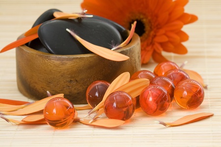 spa stones, oil bath pearls and red petalsの写真素材