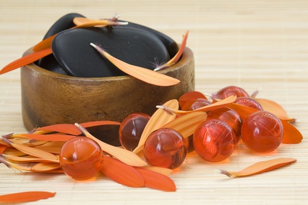 spa stones, oil bath pearls and red petalsの写真素材