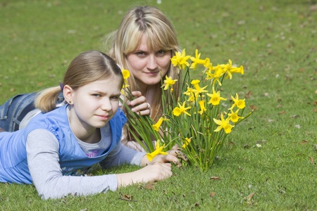  young woman and little girl in the park on a warm spring dayの写真素材