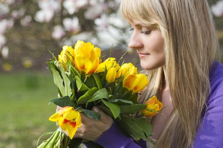 Happy woman holding flowersの写真素材