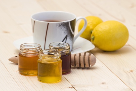 cup of tea, honey and fresh lemonsの写真素材