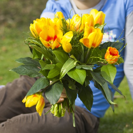 Little girl with tulips bouquetの写真素材