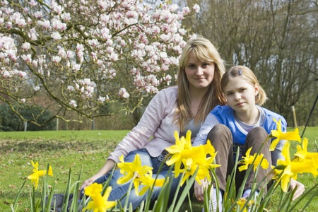 young woman and little girl in the park on a warm spring dayの写真素材