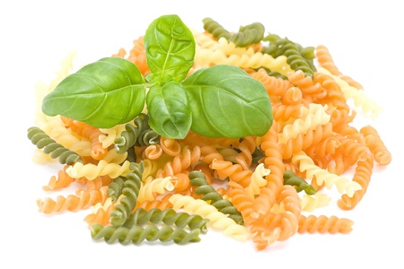 colored pasta and basil sprigの写真素材