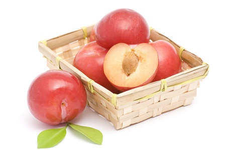 red plums in basketの写真素材