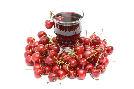 glass of fresh cherry juice and some fresh fruitsの写真素材