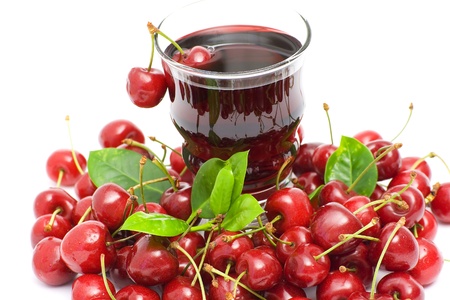 glass of fresh cherry juice and some fresh fruitsの写真素材
