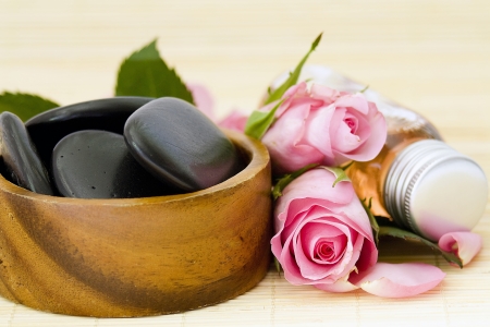 spa stones, bath oil and rosesの写真素材