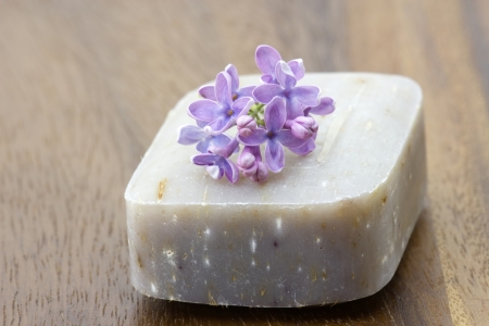 bar of natural soap and lilac flowersの写真素材