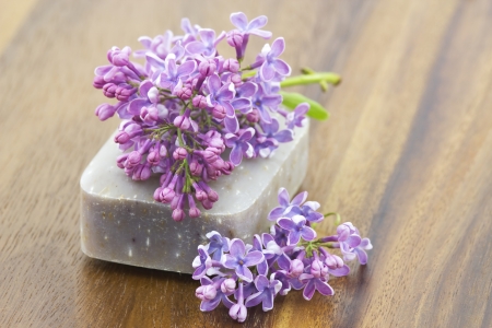 bar of natural soap and lilac flowersの写真素材