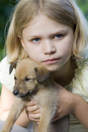 little girl and her young dogの写真素材