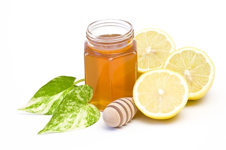 jar of honey, lemon and wooden drizzlerの写真素材