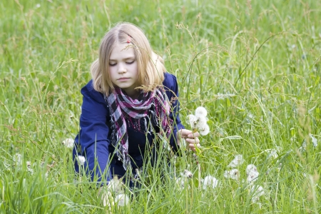 little girl on the meadow in spring day の写真素材