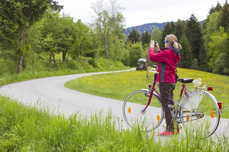 young girl with the bike in the mountains の写真素材