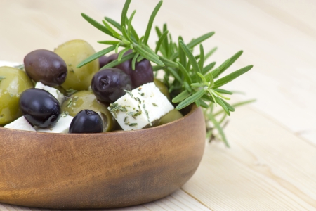 feta cheese and olives with herbs in olive oilの写真素材