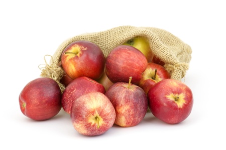 Burlap sack with apples on white backgroundの写真素材
