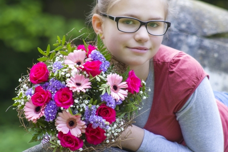 portrait of a beautiful young girl with flowers の写真素材