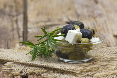 feta cheese and olives with herbs in olive oilの写真素材