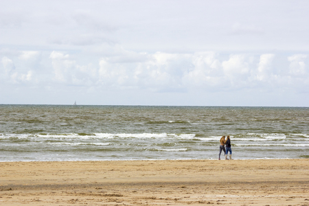 Silhouettes on the beach in the Netherlandsの写真素材