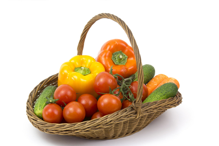 basket with fresh vegetables on white backgroundの写真素材