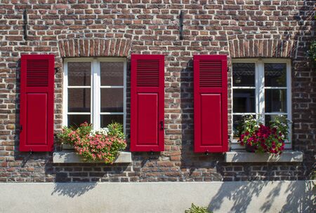 Old German house with windows with wooden shutters, Wachtendonk, North-Rhine Westphalia, Germanyの写真素材