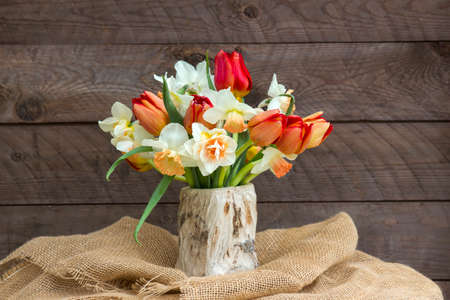 bouquet of spring flowers on wooden backgroundの写真素材