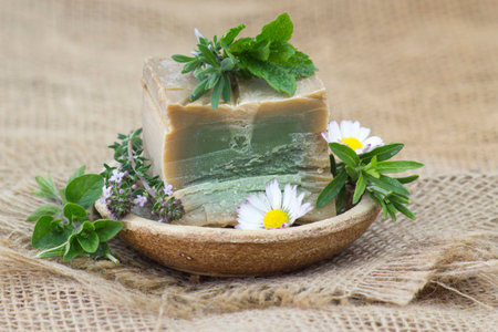 bar of natural soap, herbs and flowersの写真素材
