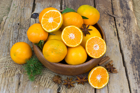 fresh tangerines in a bowl on old wooden backgroundの写真素材