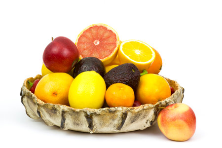 fresh fruits in a bowl on white backgroundの写真素材