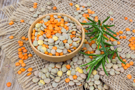 red and green lentils and rosemary on wooden backgroundの写真素材