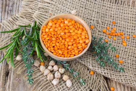 Lentils and fresh herbs - wooden backgroundの写真素材