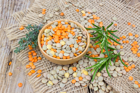 Lentils and fresh herbs - wooden backgroundの写真素材