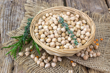 chickpeas in a basket and fresh herbsの写真素材