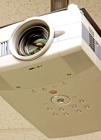 Vertical close-up of a ceiling mounted classroom projector.の写真素材