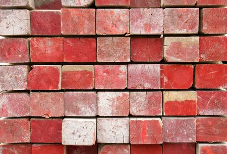 Red painted lumber tip with dirt and cracks showing, great texture and construction background.の写真素材
