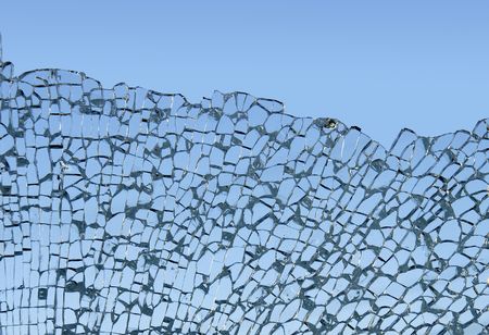 Close-up of shattered tempered glass against the skyの写真素材
