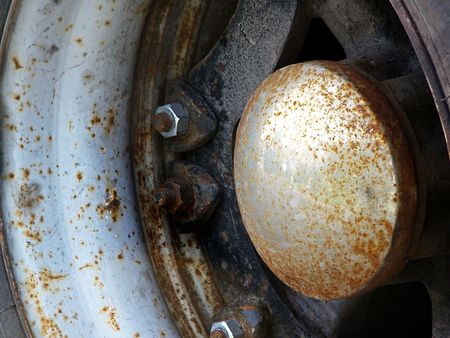 Close-up inside the wheel of an old beat up ten wheeler.の写真素材