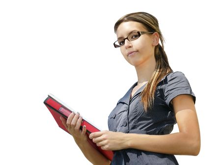Beautiful young woman with glasses holding books/paper work looking down at camera with hint of a smile, isolated on white background. Can be student/teacher/young professional.の写真素材