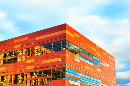 Stunnig design for a new modern building, corner office concept, shot against cloudy sky.の写真素材