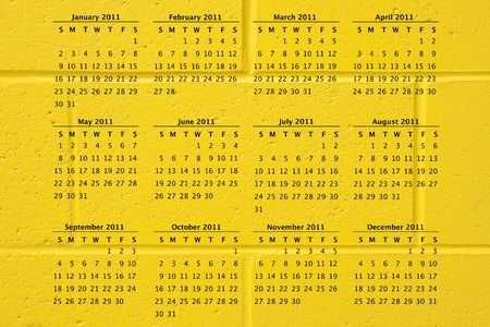 2011 calendar on fun school yellow cement block wall background, great texture.の写真素材